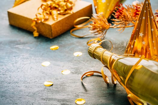Happy New Year celebration,  bottle of champagne, bright lights and gifts