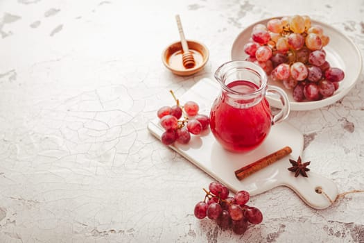 Homemade organic red vinegar with cinnamon and anise. Red grape balsamic vinegar made from fermented fresh grapes.