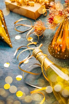 Happy New Year celebration,  bottle of champagne, bright lights and gifts