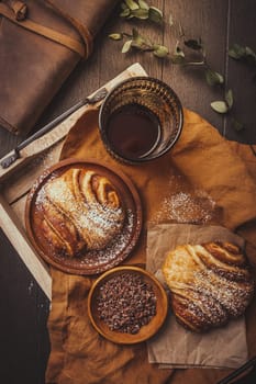 Cinnamon rolls or Franzbroetchen -  Germany sweet pastry sweet pastry baked with butter and cinnamon,  croissant with cocoa chips