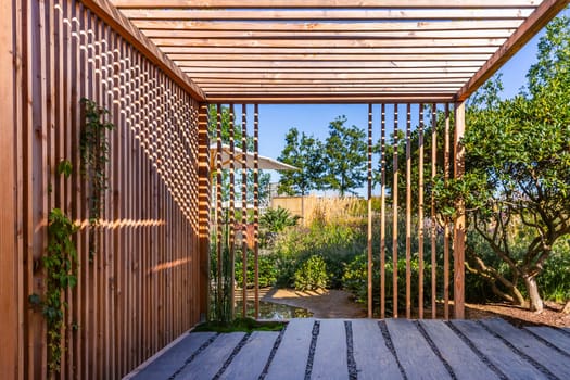 Modern wooden arbor. Modern wooden roofing in courtyard, backyard, terrace or patio