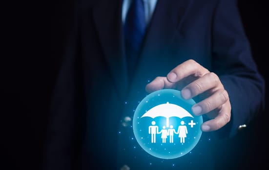 Concept of health insurance and medical benefits. Businessman showing family icons in house frame and plus sign. Health insurance and access to health care. Health care planning.
