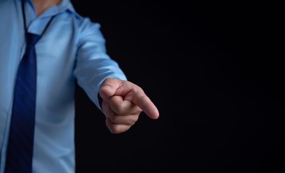 Employee makes a forward pointing gesture on a dark background.