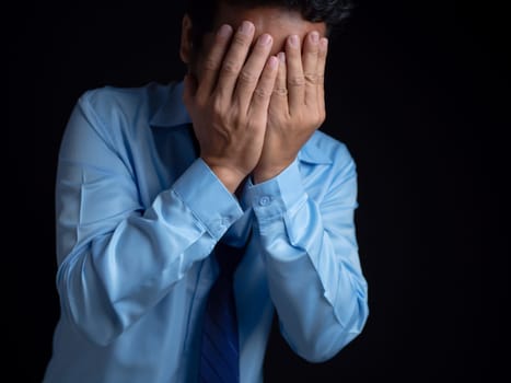 Businessman acted tired headache stressed and anxious from the frustrated business crisis, expresses disappointment, regret, making a mistake.