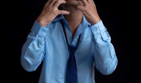 Businessman acted tired headache stressed and anxious from the frustrated business crisis, expresses disappointment, regret, making a mistake.