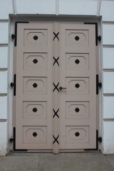 A detailed  picture of a restored, ornately decorated old front door