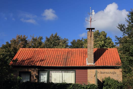 Nice little house, built of red brick, blue sky in the background