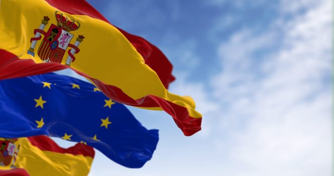 National flags of Spain waving with the European Union flag on a clear day. International cooperation. 3d illustration render. Rippled fabric. Selective focus