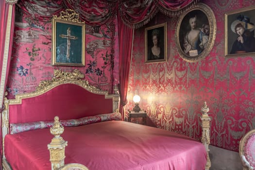 Masino, Italy - April 2023: baroque bedroom in old castle. Vintage interior, original from 18th Century