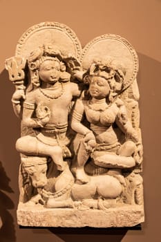 Turin, Italy - May 2023: Oriental Art Museum - Shiva, the Hindu god, with his wife Parvati. Concept for tantra, Kamasutra, tantric sex