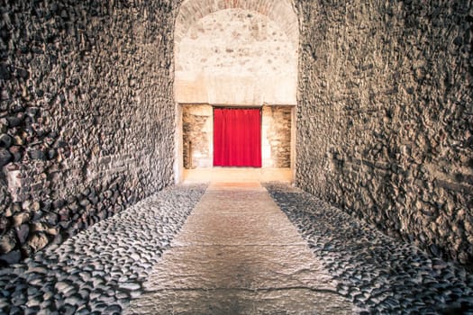 Old corridor with red curtain at the end. Concept for mystery, gothic, escape, hope