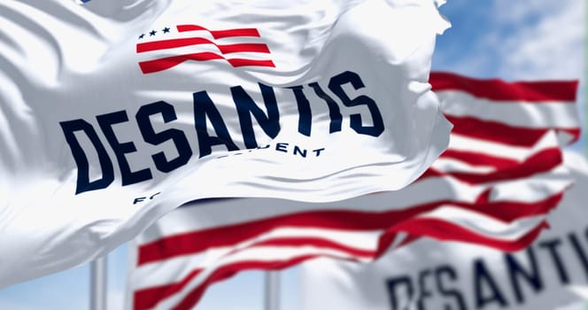 Tallahassee, US, Nov. 30 2023: Ron DeSantis 2024 Republican presidential primaries campaign flags waving with national US flag. Illustrative editorial 3d illustration render. Republican primaries
