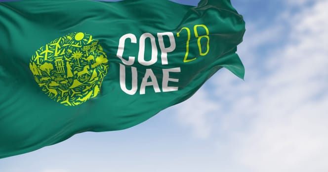 Dubai, UAE, Nov. 30 2023: Close-up of COP28 flag waving on a clear day. Illustrative editorial 3d illustration render.