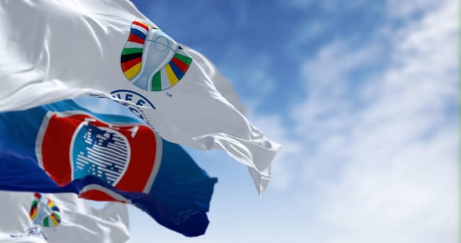 Berlin, DE, June 30 2023: UEFA and UEFA Euro 2024 European Football Championship flags waving on a clear day. International Sport event. Illustrative editorial 3d illustration render