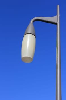 A street lamp, with blue sky in the background