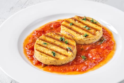 Portion of grilled cheese with tomato basil sauce