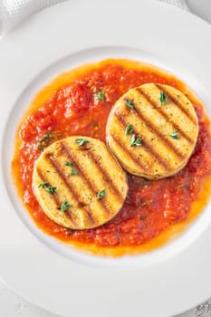 Portion of grilled cheese with tomato basil sauce