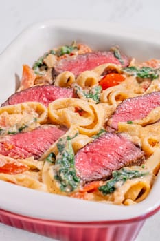 Creamy steak fettuccine pasta with spinach and tomatoes
