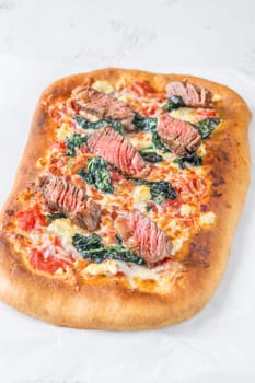 Beef steak focaccia with spinach and cheese