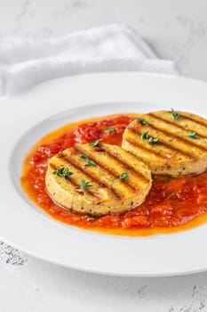 Portion of grilled cheese with tomato basil sauce