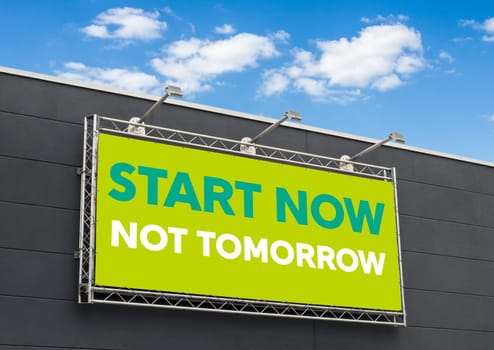 Start now not tomorrow written on a billboard
