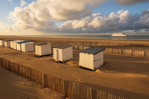 Beautiful landscape of the coast and harbor with cabins and the departure of a ferry in Calais, north of France