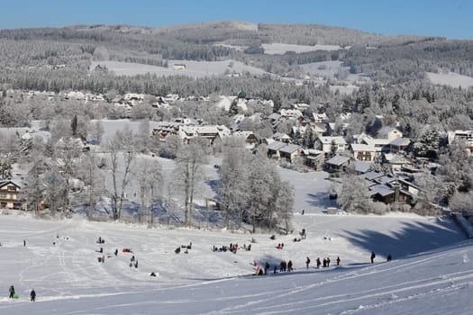 View of the wintry snow-covered Hinterzarten. Winter hikers and tobogganers visit the climatic health resort  In picture-perfect weather with blue skies,pure sunshine and over half a metre of snow,the ski season was opened on the 1,493-metre-high Feldberg (Breisgau-Hochschwarzwald district). Several hundred winter sports enthusiasts frolicked in the snow on skis and snowboards. Others took the opportunity for a first winter walk or a toboggan ride in a dreamlike snow-covered winter landscape on the Höchsten. But in the next few days the weather is expected to become more unstable again