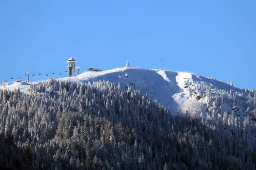 The snow-covered Feldberg and Feldberg Tower with the Baldenweger Buck  Feldberg - Opening of the winter sports season 2023-24  In picture-perfect weather with blue skies,pure sunshine and over half a metre of snow,the ski season was opened on the 1,493-metre-high Feldberg (Breisgau-Hochschwarzwald district). Several hundred winter sports enthusiasts frolicked in the snow on skis and snowboards. Others took the opportunity for a first winter walk or a toboggan ride in a dreamlike snow-covered winter landscape on the Höchsten. But in the next few days the weather is expected to become more unstable again