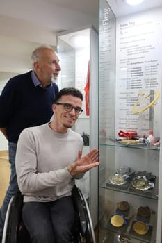 Alfred Faller (Director of the Black Forest Ski Museum) and Martin Fleig (Paralympic champion,overall World Cup winner and world champion) marvel at the medal collection in the new display case in the Black Forest Ski Museum: Paralympic champion Martin Fleig hands over medals   DFL REGULATIONS PROHIBIT ANY USE OF PHOTOGRAPHS AS IMAGE SEQUENCES AND/OR QUASI-VIDEONann  Photo: Joachim Hahne/johapress