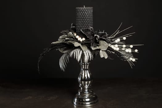Floral bouquet with a gray candle to decorate the holidays using dried flowers in a silver-white design