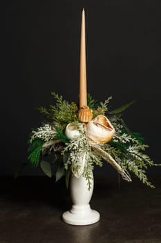 Floral bouquet with a beige candle to decorate the holidays using dried flowers