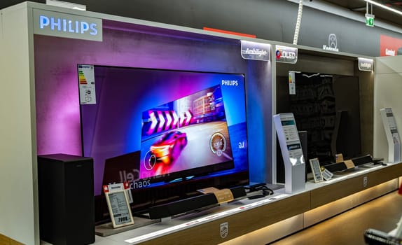 POZNAN, POL - DEC 8, 2023: Modern flat-screen TV sets put up for sale in an electronics store