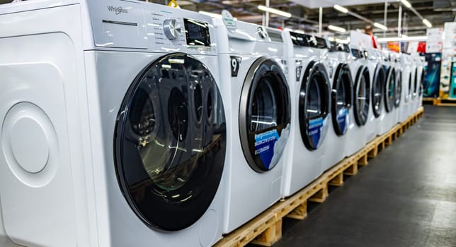 POZNAN, POL - DEC 8, 2023: Front-loader washing machines by Whirlpool put up for sale in a household goods store