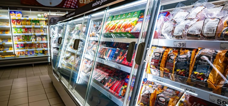 POZNAN, POL - DEC 8, 2023: Food products put up for sale in a commercial refrigerator
