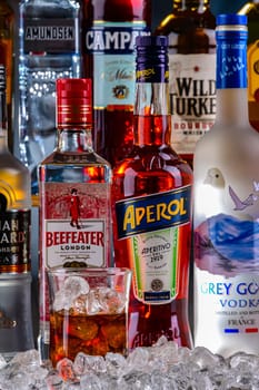POZNAN, POL - NOV 29, 2023: Bottles of assorted global hard liquor brands in a bar