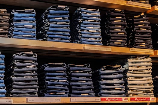POZNAN, POL - DEC 8, 2023: Clothing products on the shelf in a clothing store.