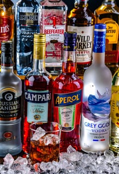 POZNAN, POL - NOV 29, 2023: Bottles of assorted global hard liquor brands in a bar
