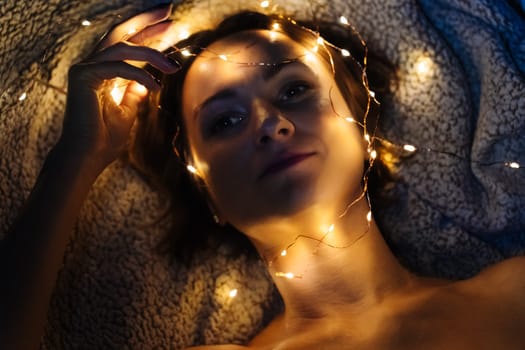Close-up of a woman's face with festive lights