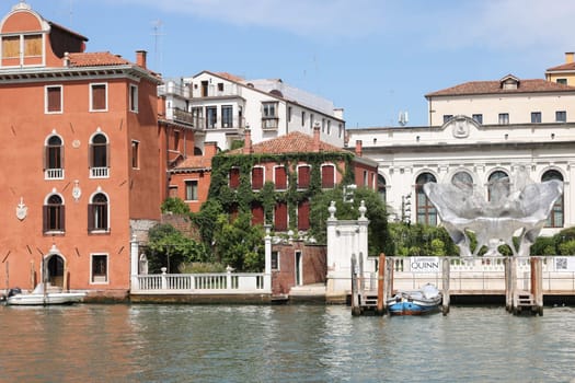 Venice, Italy - September 5, 2022: Baby 3.0 the monumental sculpture by Lorenzo Quinn in the garden of Ca’ Corner della Ca’ Granda palace in Venice.