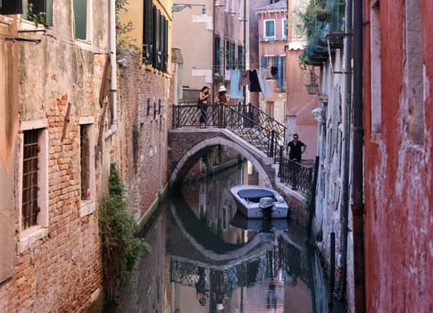 Venice, Italy - September 5, 2022: Romantic narrow canals crossed by bridges in the San Marco district of Venice