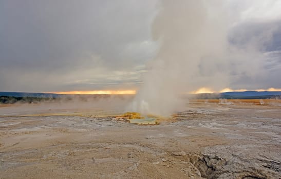 Sunset and Clouds by Clepsydra Geyser in Yellowstone National Park in Wyoming