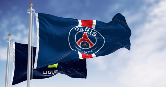 Paris, FR, dec 3 2023: Paris Saint Germain football club and Ligue 1 flags waving on a clear day. Illustrative editorial 3d illustration render. Selective focus