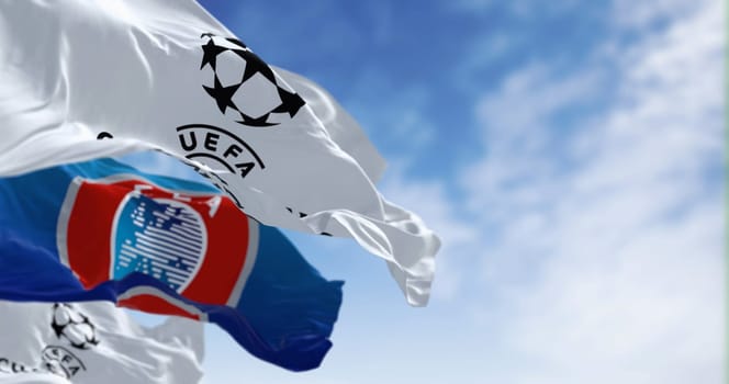 London, UK, Dec 1 2023: UEFA and UEFA Champions league flags waving together. European football competition. Rippled fabric. Illustrative editorial 3d illustration render. Selective focus