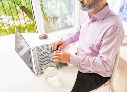Man working with notebook and smartphone. Smart working.