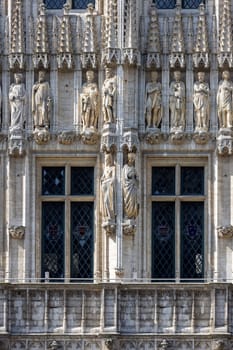 Brussels, Belgium - May 17, 2023: Medieval Town Hall in Grand Place, main market in the city. Statues of Dukes and Duchesses of Brabant on facade