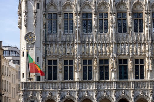 Brussels, Belgium - May 17, 2023: Medieval Town Hall in Grand Place, main market in the city. Clock on decorative facade