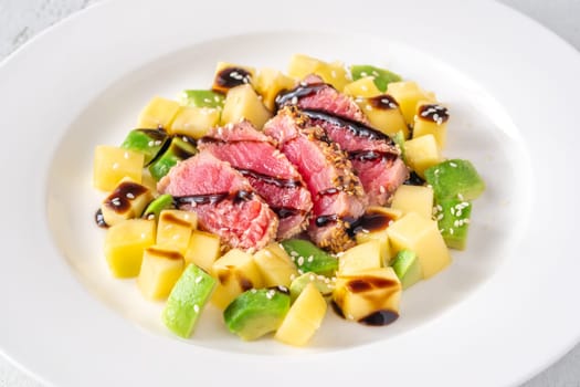 Portio of tuna with mango and avocado