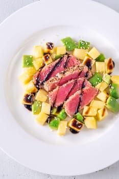 Portio of tuna with mango and avocado