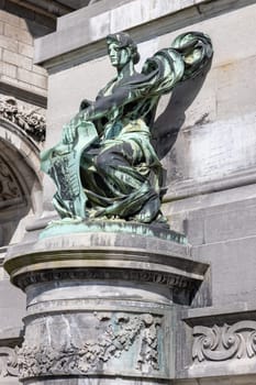 Brussels, Belgium - May 16, 2023: One of the sculptures on the base of triumphal arch Cinquantenaire Arch in Cinquantenaire Park