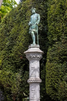 Brussels, Belgium - May 18, 2023: One of the 48 statues embodying various Brussels guilds in renaissance garden of Square of Petit Sablon